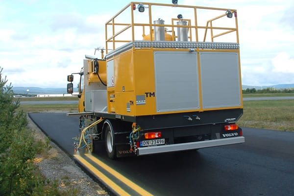 Line painting vehicle with equipment painting lines on road