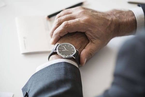 Man looking at watch to see reminders produced by our liquid waste management software